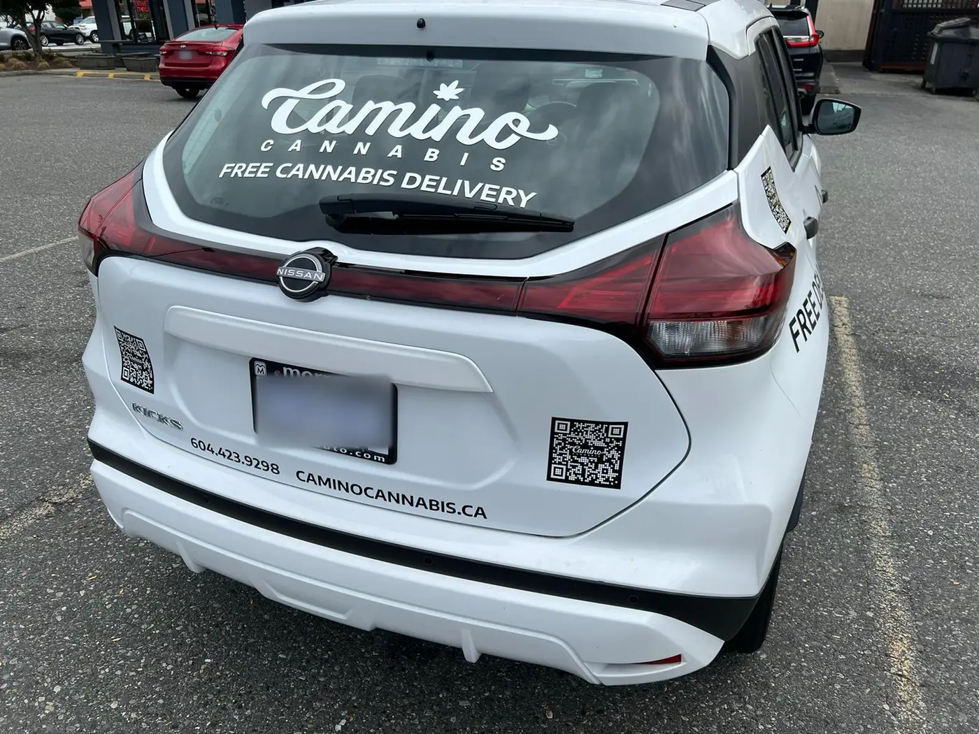 Rear of the Camino Cannabis delivery car with Free Cannabis Delivery on the back window, phone number 604.423.9298 and caminocannabis.ca